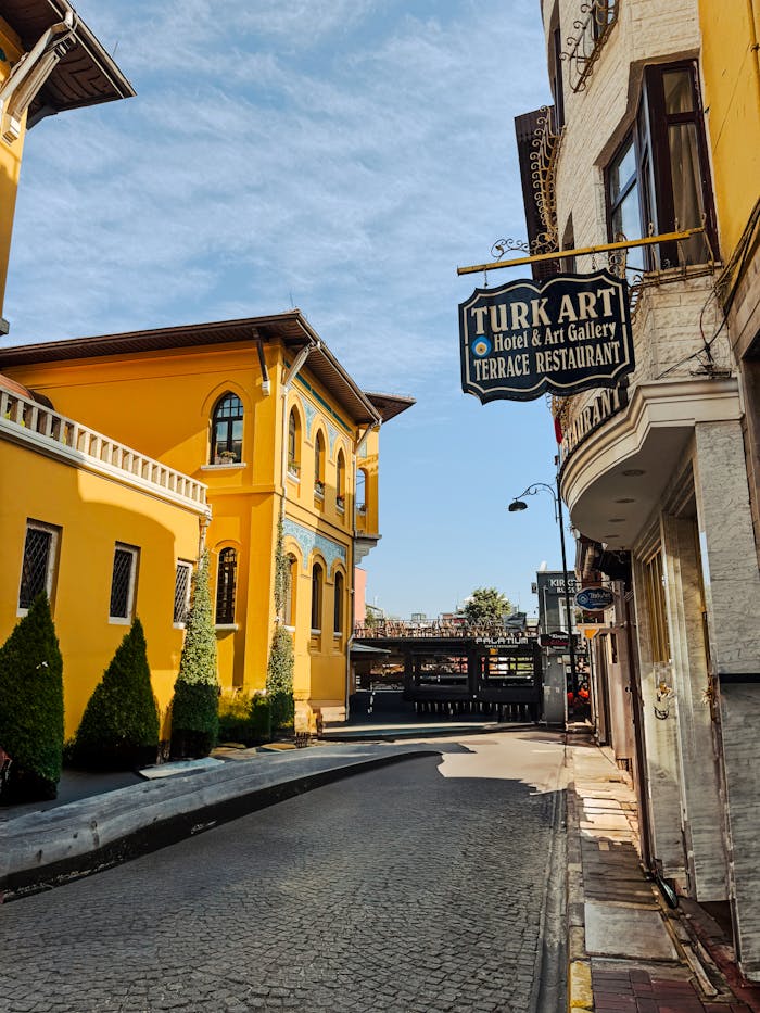 Vibrant street scene in Istanbul showcasing colorful historic architecture with a clear blue sky backdrop.
