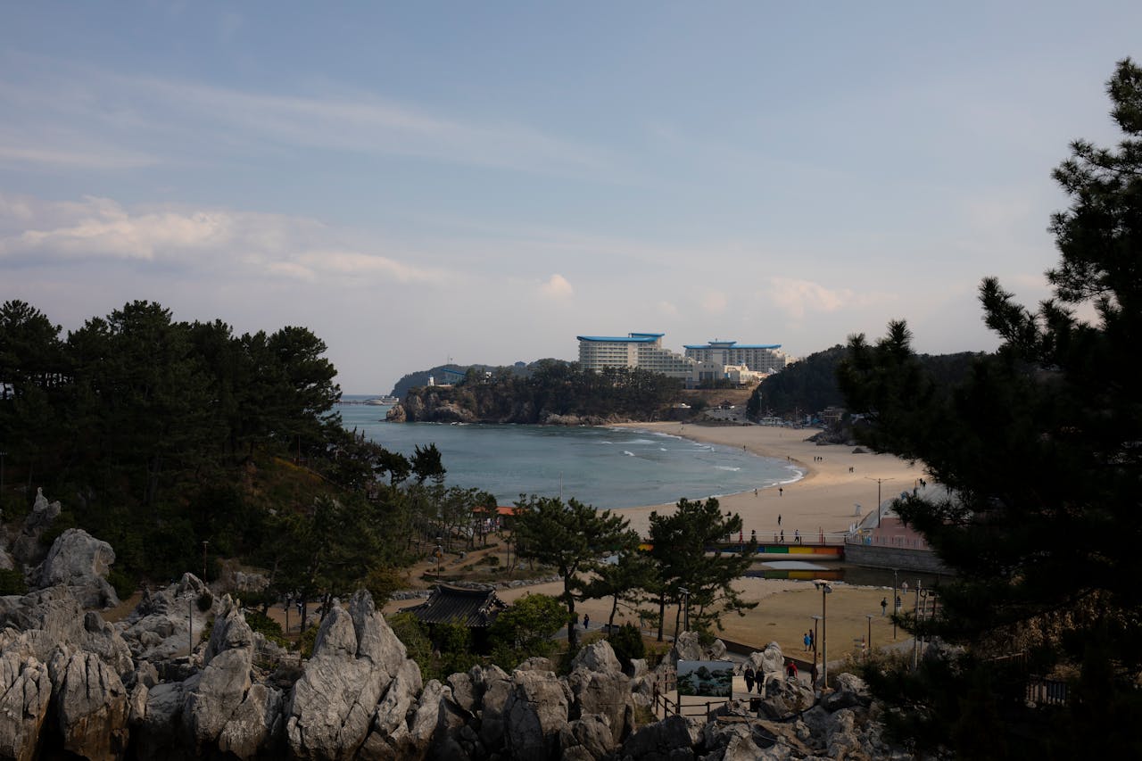 A tranquil beachfront scene with a resort in the background, ideal for travel and vacation themes.